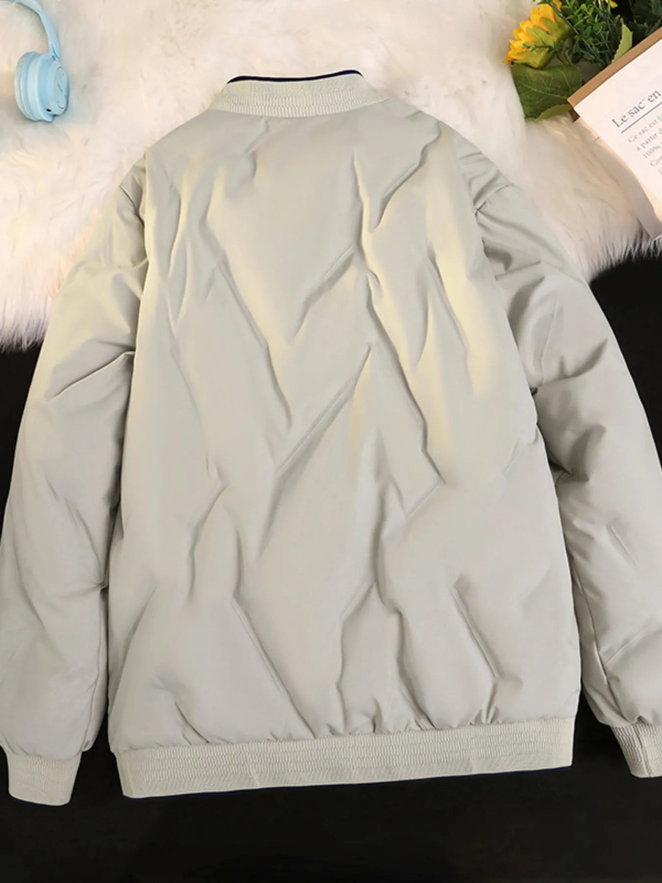 Plus-size quilted bomber jacket in ivory with diamond pattern and ribbed cuffs and hem.
