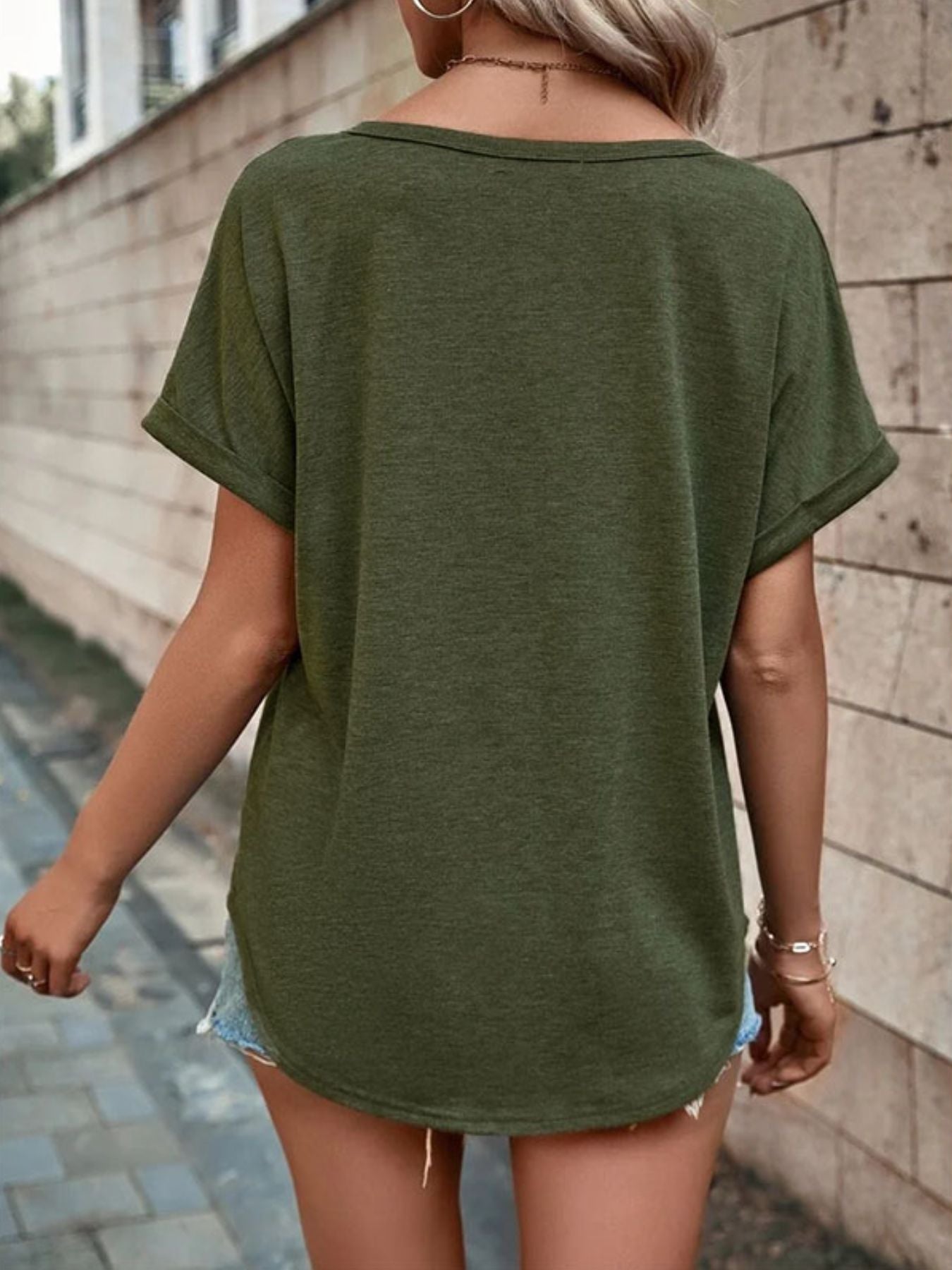 Army green short sleeve t-shirt with decorative buttons and a V-neck.