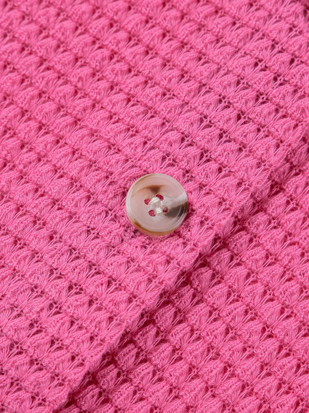 Pink waffle-knit button-down maternity shirt with a single button detail.