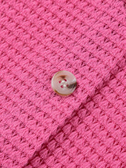 Pink waffle-knit button-down maternity shirt with a single button detail.