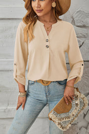Ivory V-neck button-down blouse with cuffed sleeves and a relaxed fit.