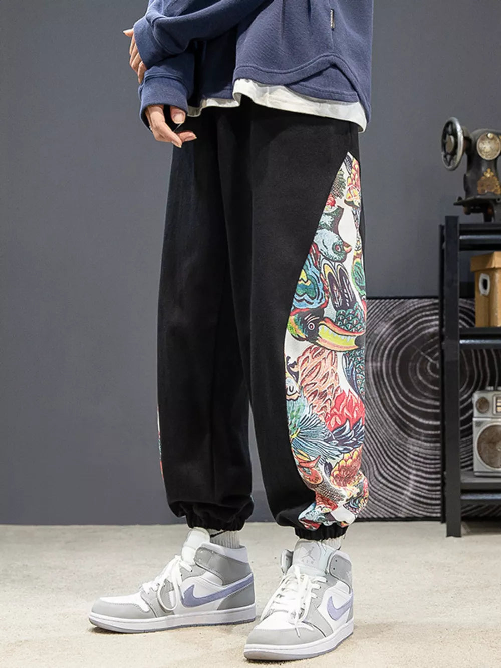 Black joggers with vibrant side panel print and elastic cuffs