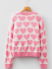 Charming heart pattern knit sweater in blush pink acrylic with crew neck and ribbed trim.