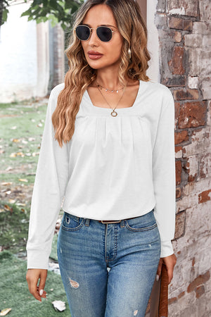 White long sleeve top with square neckline and subtle pleats, casual chic style
