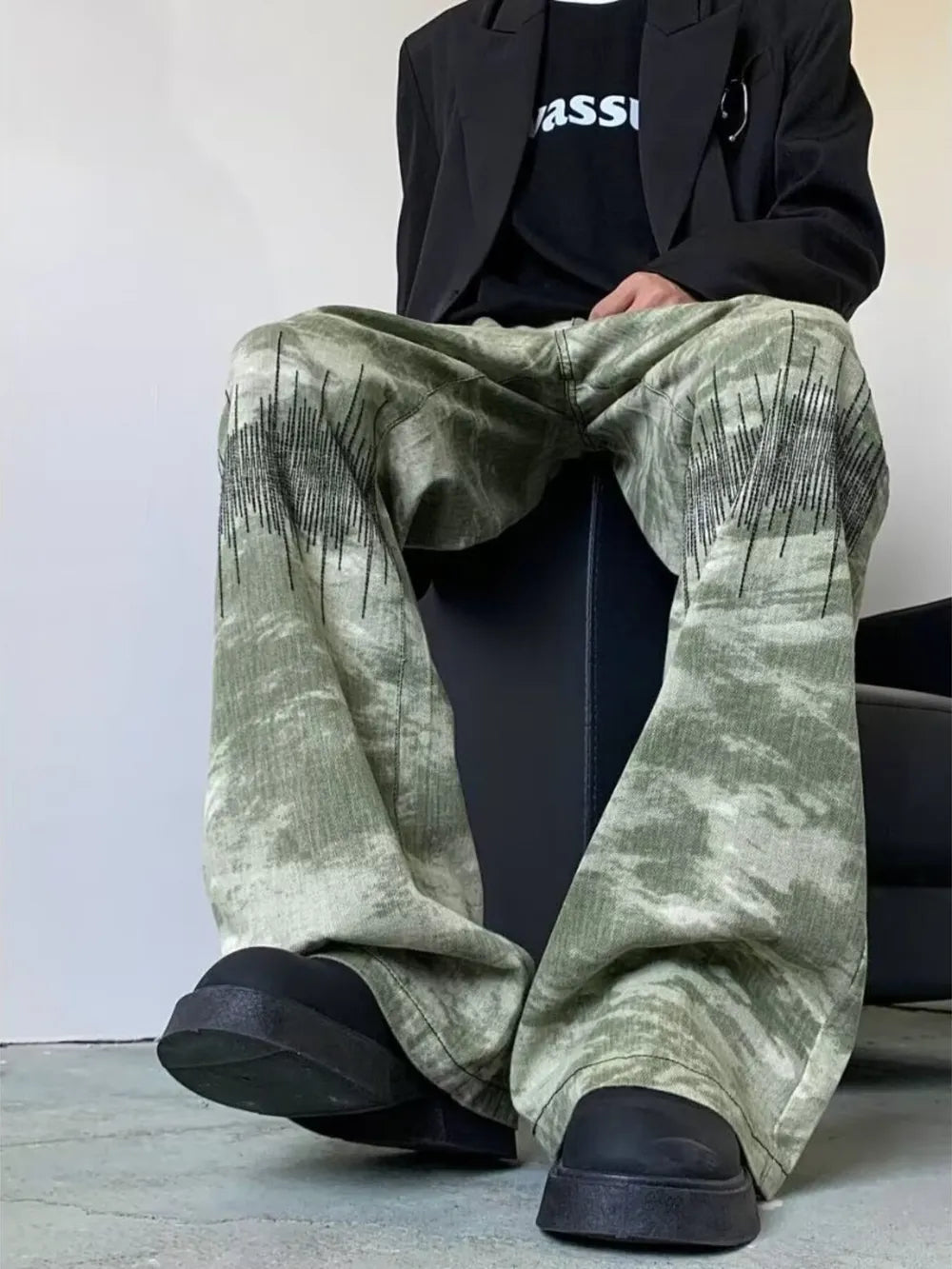 Abstract print wide-leg jeans in green with black graphic detail.