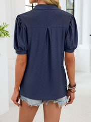 Navy blue eyelet collar top with puff sleeves and a textured pattern.