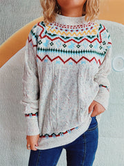 Beige Fair Isle cable knit turtleneck sweater with multicolor pattern and speckles.
