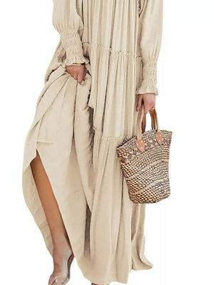 Apricot smocked v-neck tiered maxi dress with long sleeves and a high slit.