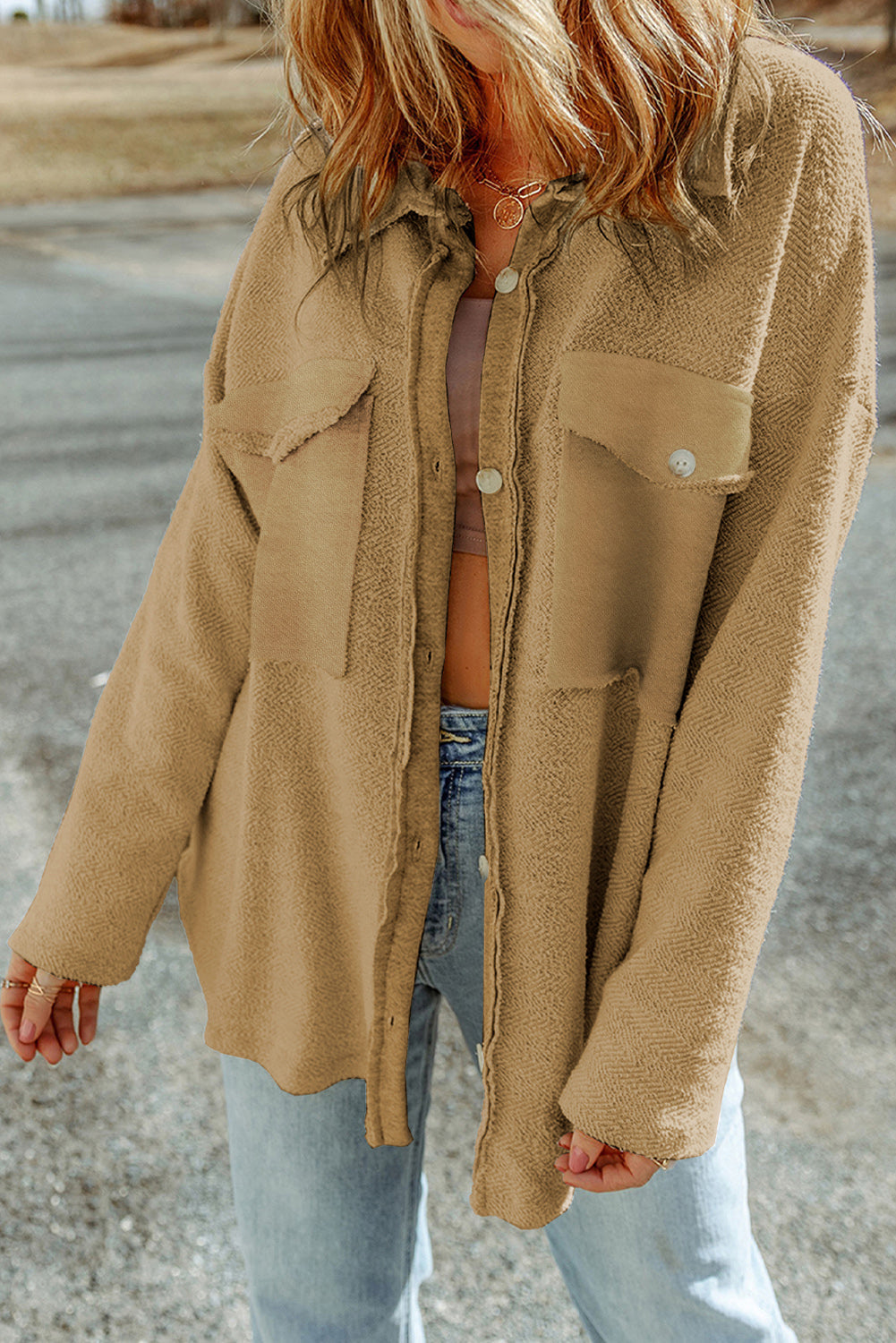 Camel textured shacket with raw edge detailing and buttoned pockets.