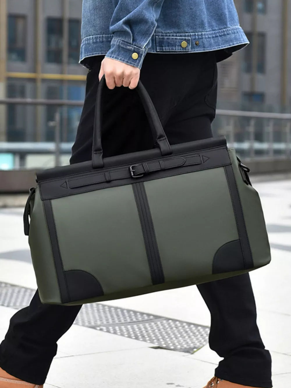 Green Oxford cloth travel duffel bag with black trim and buckle detail.