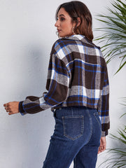 Chic plaid jacket in dark blue, white, and brown with button details.