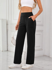 Black wide-leg lounge trousers with patch pockets and a comfortable fit.