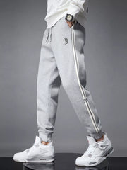 Light gray cotton joggers with side stripes and cuffed ankles.