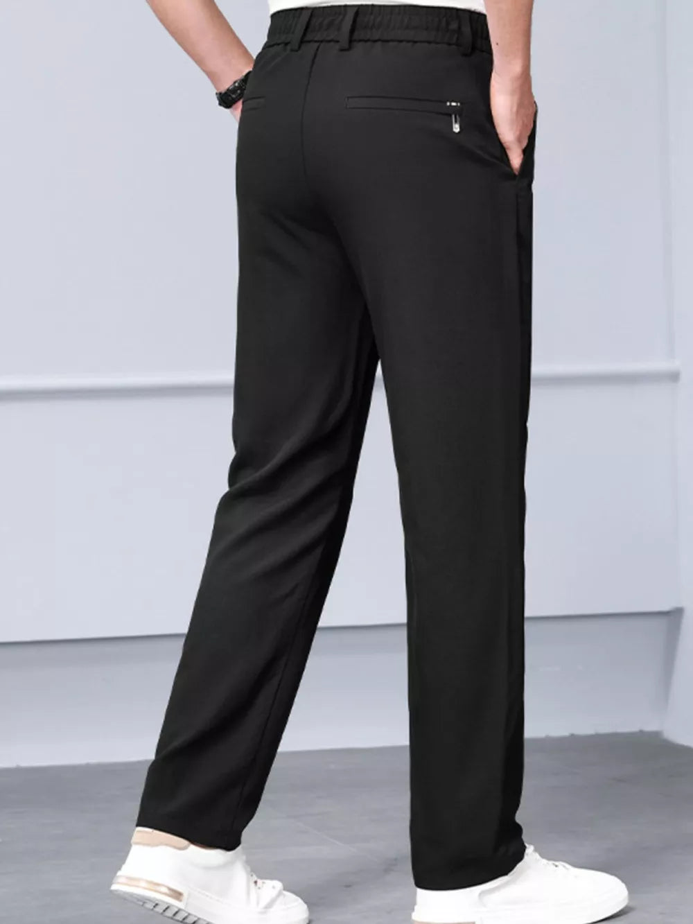 Black classic fit sweatpants with elastic waist and zippered back pocket detail.