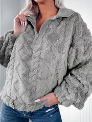 Textured gray fleece quarter zip sweatshirt with diamond pattern and ribbed collar.