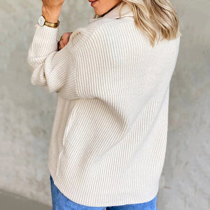 Ivory ribbed knit polo with button detail and casual cut.