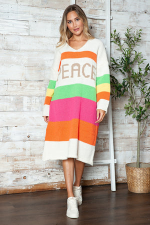 Beige sweater dress with rainbow stripes and "PEACE" lettering, V-neck, midi length