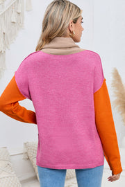 Colorblock knit turtleneck sweater in pink with tan collar and orange sleeves.