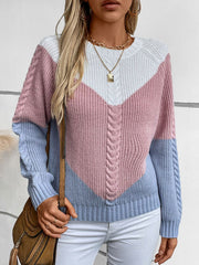 Chevron cable knit sweater in pastel blue, blush pink, and white with a V-shaped colorblock design.