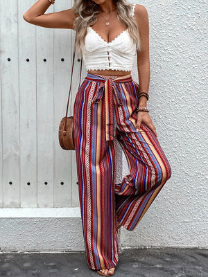 Bohemian stripe palazzo trousers in rust with a tie waist and wide leg.