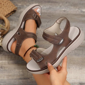 Brown open-toe sandals with contrast stitching and adjustable straps.