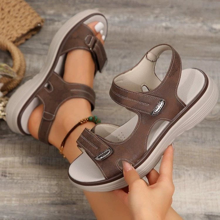 Brown open-toe sandals with contrast stitching and adjustable straps.