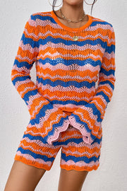 Crochet flare set with orange-red, blue, and pink zig-zag stripes, bell sleeves, and scalloped hem shorts.