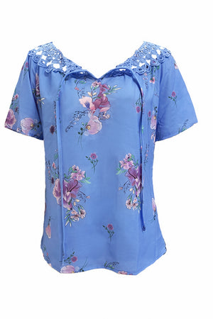 Blue floral blouse with lace yoke and tie-neck detail.