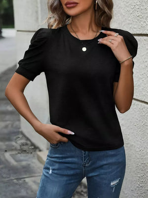 Black t-shirt with puff sleeves and a crew neck, styled with jeans.