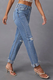 Medium wash distressed straight leg jeans with ripped knees and cuffed hems.