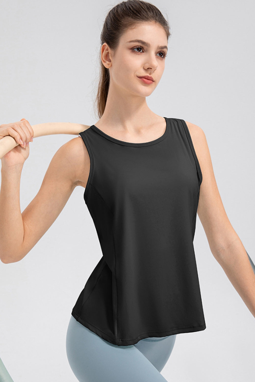 Black performance tank top with scoop neck and curved back panel detail