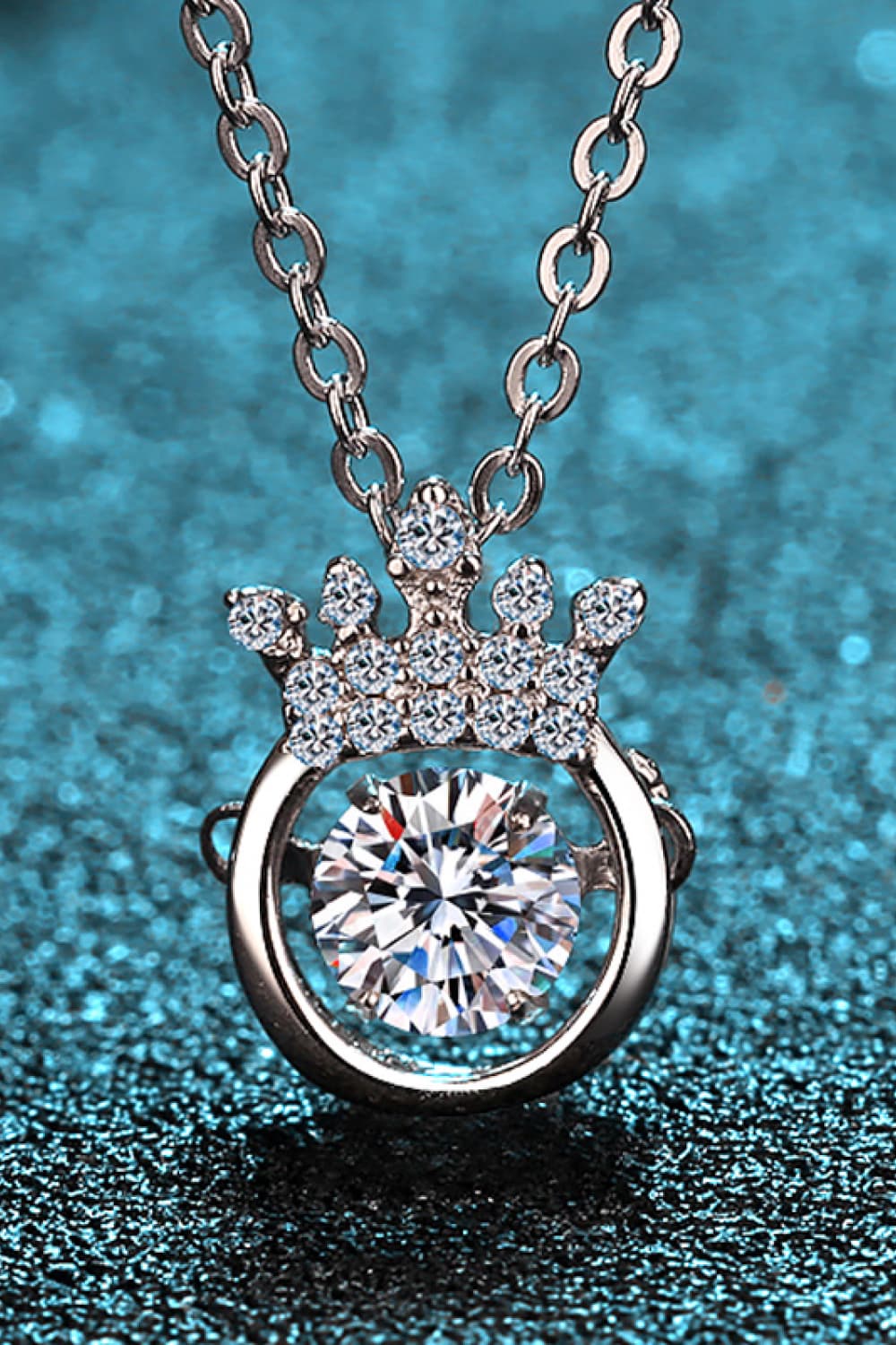 Silver pendant necklace with a crown design and a central diamond.