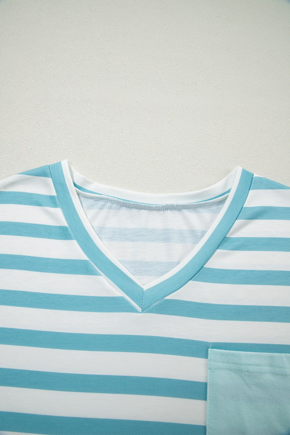 Striped V-neck t-shirt in teal and white with a chest pocket.