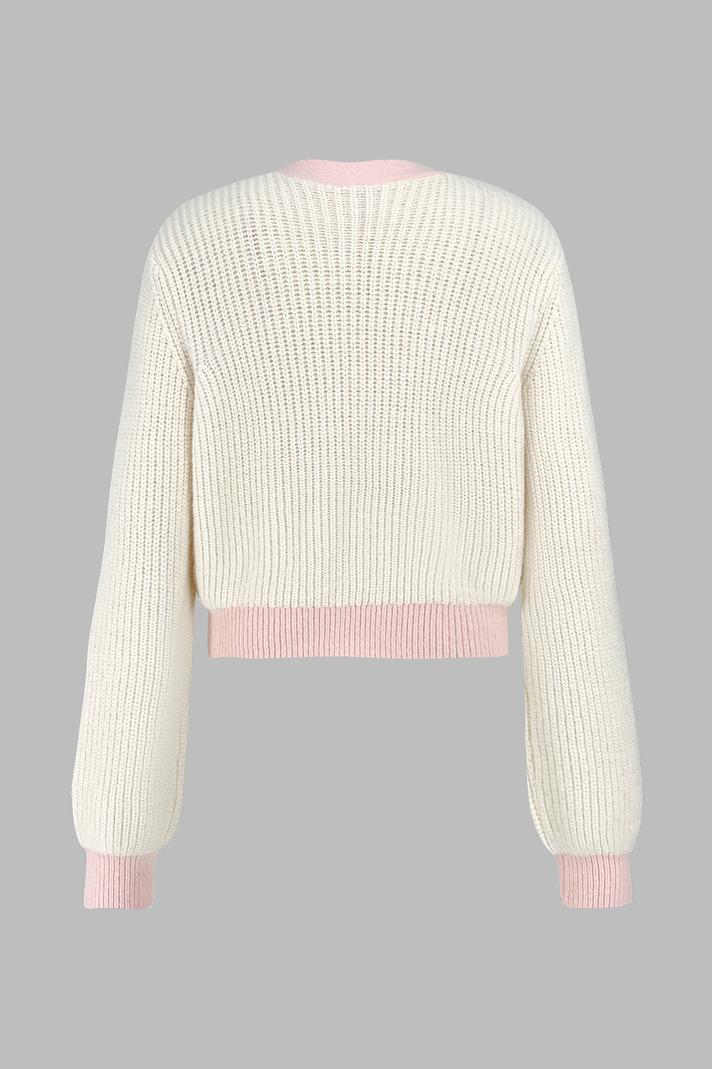 Cream acrylic cropped knit cardigan with contrast pink trim and cuffs.