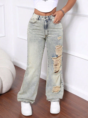 Distressed wide-leg acid wash jeans in light denim with ripped details.