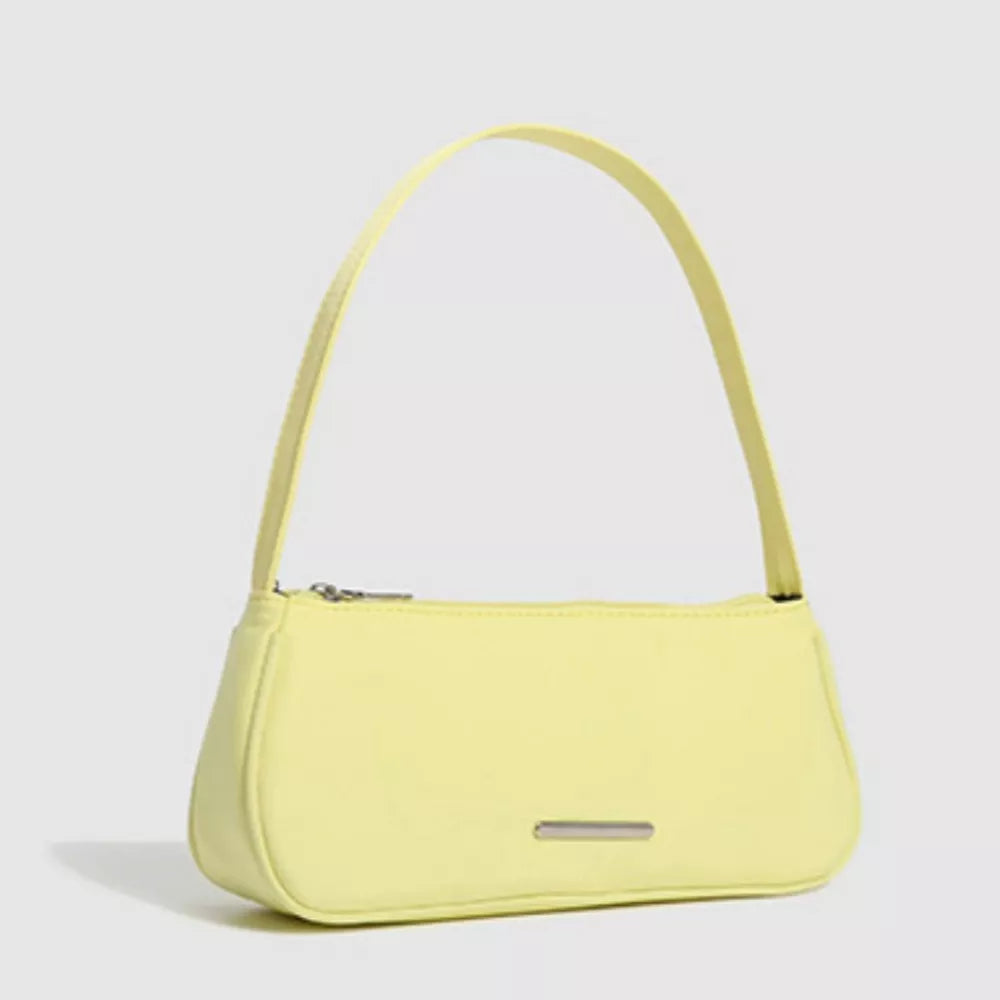 Sleek mini nylon shoulder bag in pale yellow with a silver accent plate.