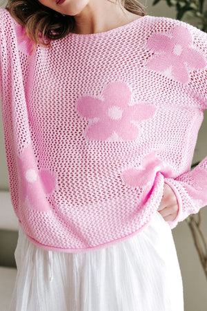 Openwork blush pink acrylic sweater with floral intarsia pattern and crew neck.