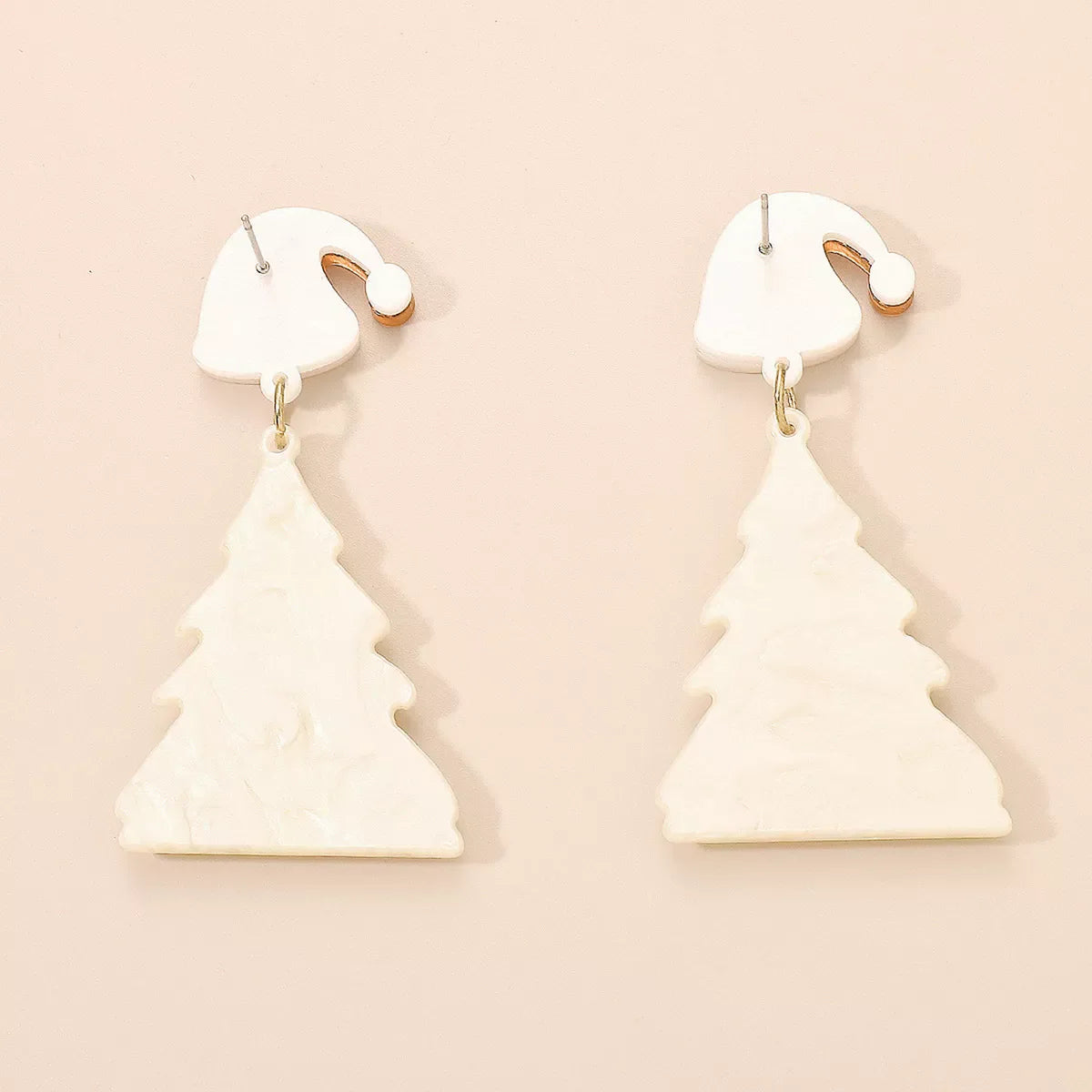 White acrylic Christmas tree dangle earrings with Santa hat tops.