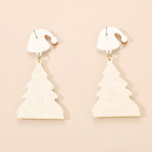 White acrylic Christmas tree dangle earrings with Santa hat tops.