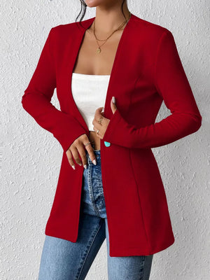Red single-button blazer with tailored fit and open front, styled with jeans.
