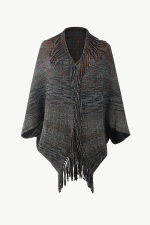 Textured stripe fringe cape in gray acrylic with a V-neck and fringed hem.