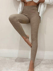 Camel ribbed knit stirrup leggings with a high waist and split hem.