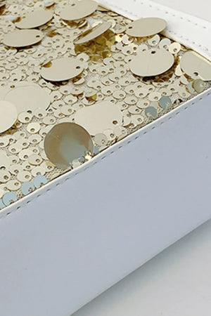 White structured mini bag with gold sequin embellishments and white trim.