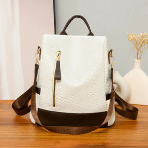Ivory woven faux leather convertible backpack with brown trim and gold zipper.