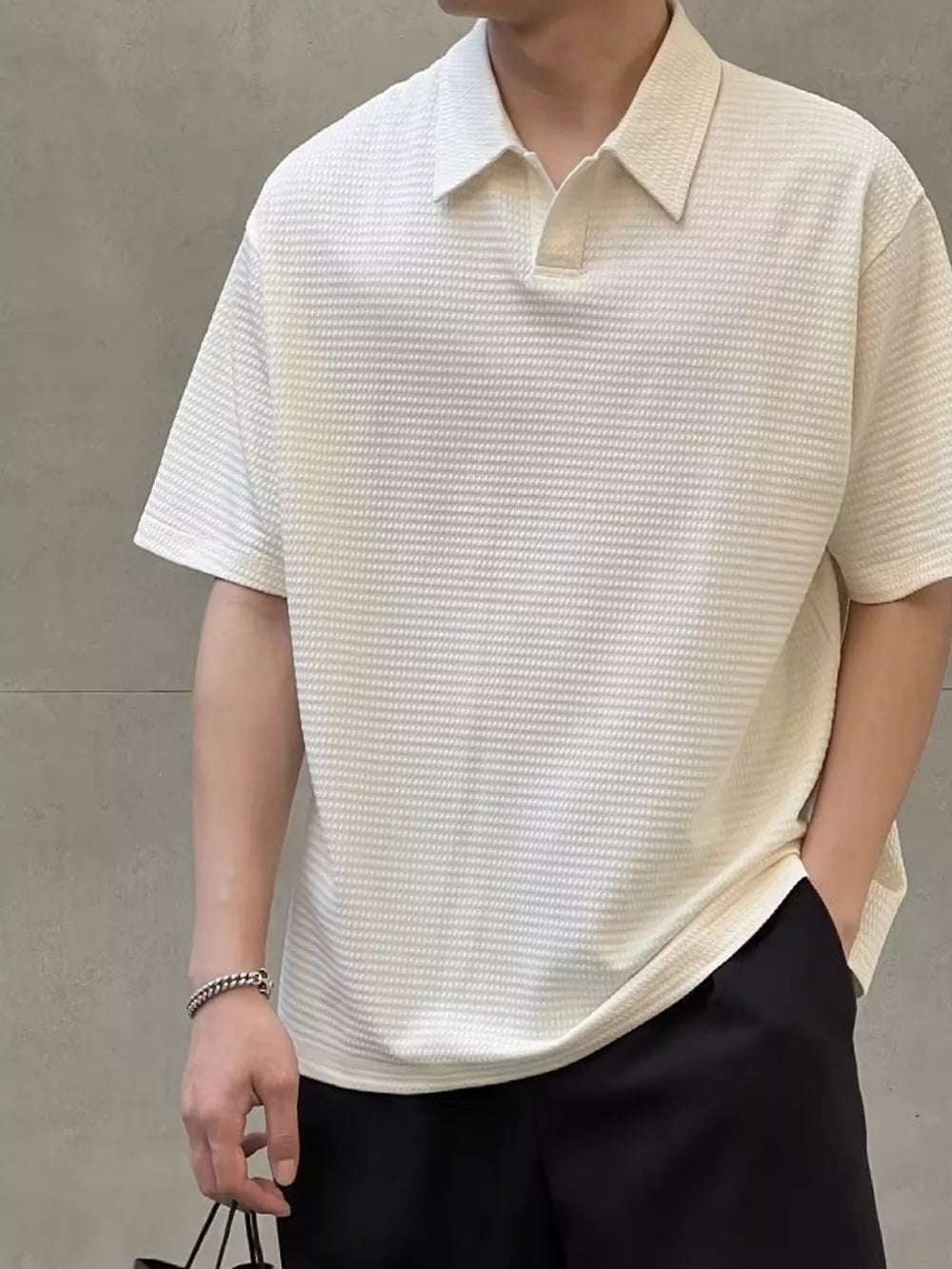 Men's eggshell textured waffle knit polo shirt with short sleeves and a buttoned collar.