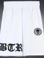 White Gothic script graphic shorts with skull logo detail.