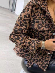 Leopard print denim shacket with raw hem and buttoned pockets.