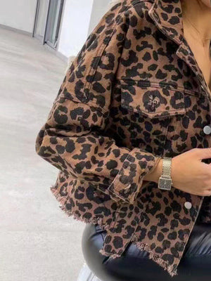 Leopard print denim shacket with raw hem and buttoned pockets.