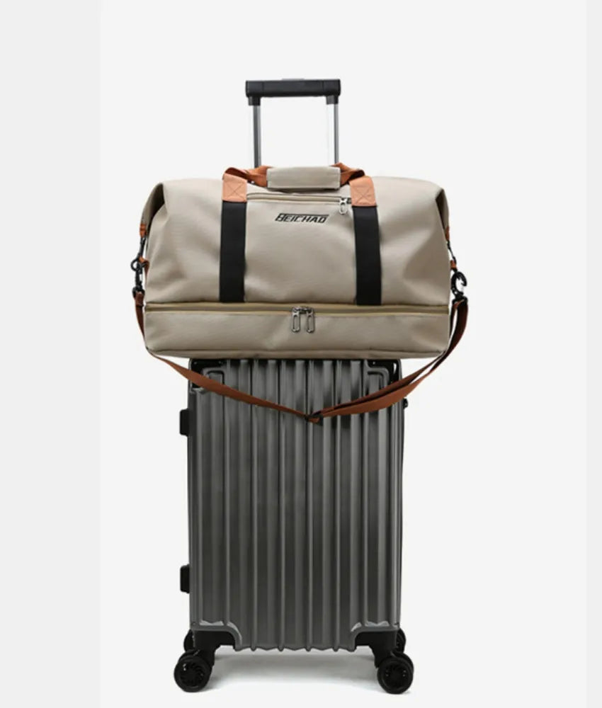 Khaki dual-compartment weekender bag with black and brown contrast straps on a rolling suitcase.