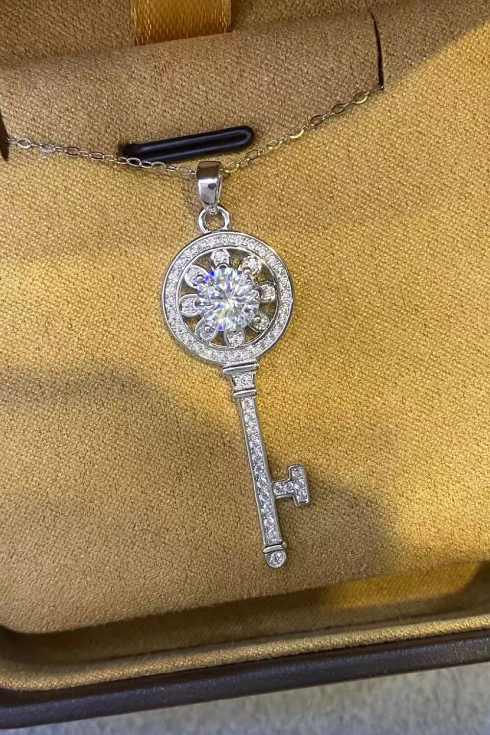 Silver key pendant necklace with floral charm and clear crystals